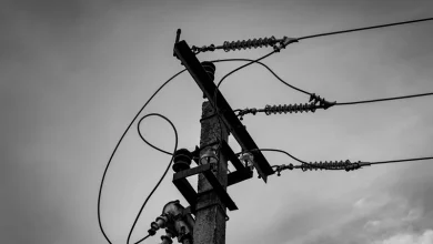 Hyderabad Summer Electricity Demand Power lines against a cloudy sky