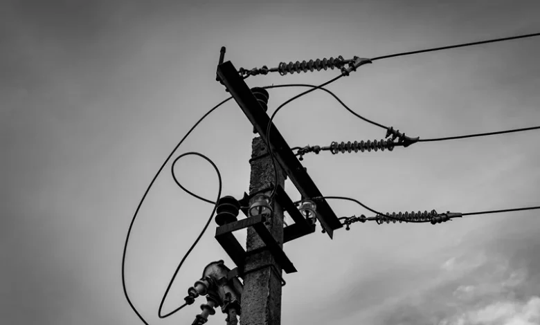 Hyderabad Summer Electricity Demand Power lines against a cloudy sky
