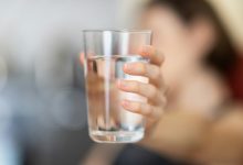 drinking water quality Person holding a glass of water