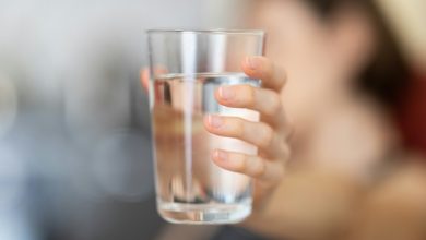 drinking water quality Person holding a glass of water