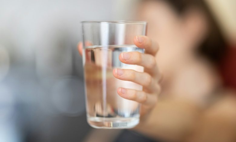 drinking water quality Person holding a glass of water