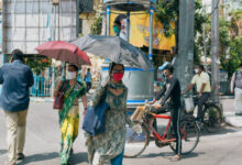 people using umbrellas for heatw people using umbrellas for heatw