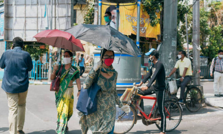 people using umbrellas for heatw people using umbrellas for heatw